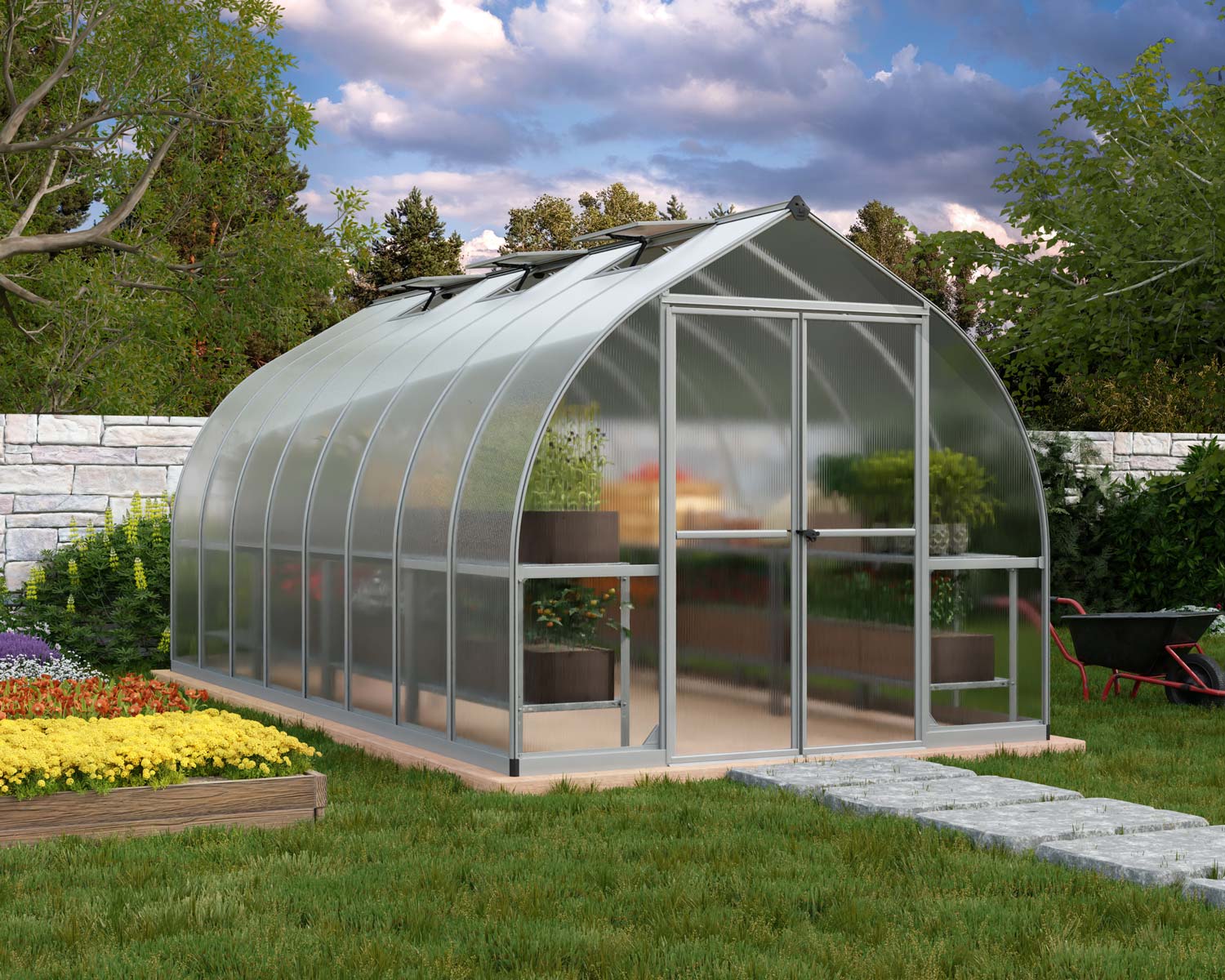 Bella 8x16 Silver greenhouse with polycarbonate panels, double doors, and a sloped roof, set in a lush garden