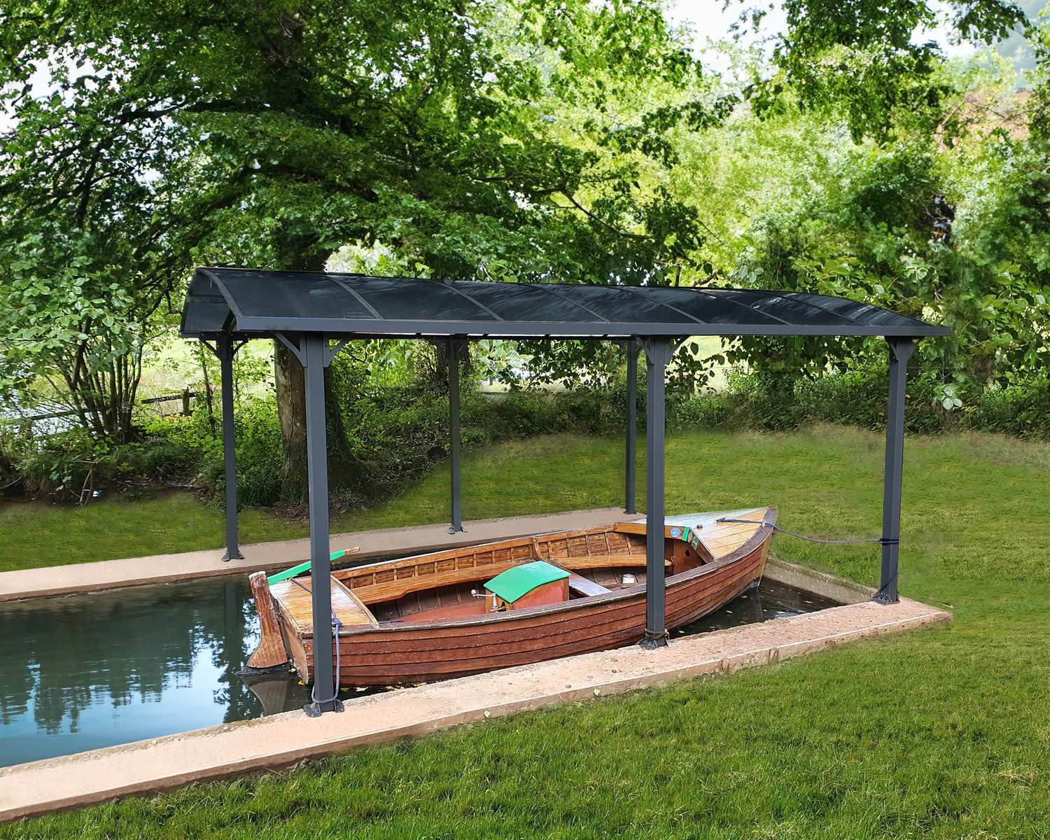 wooden boat under a grey 12ft x 17ft Arcadia aluminum carport with a modern design