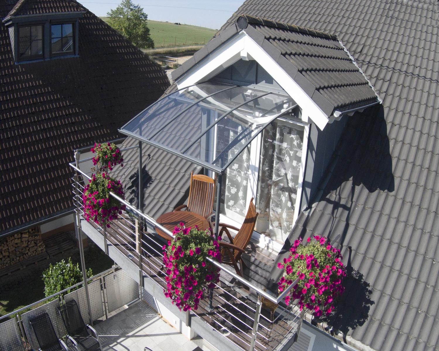 Sleek grey Vega door awning 7 ft x 7 ft featuring clear panels, stylishly positioned above a door for a contemporary look