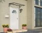 Stylish grey Venus door awning 3 ft x 5 ft featuring clear panels, elegantly positioned above a door