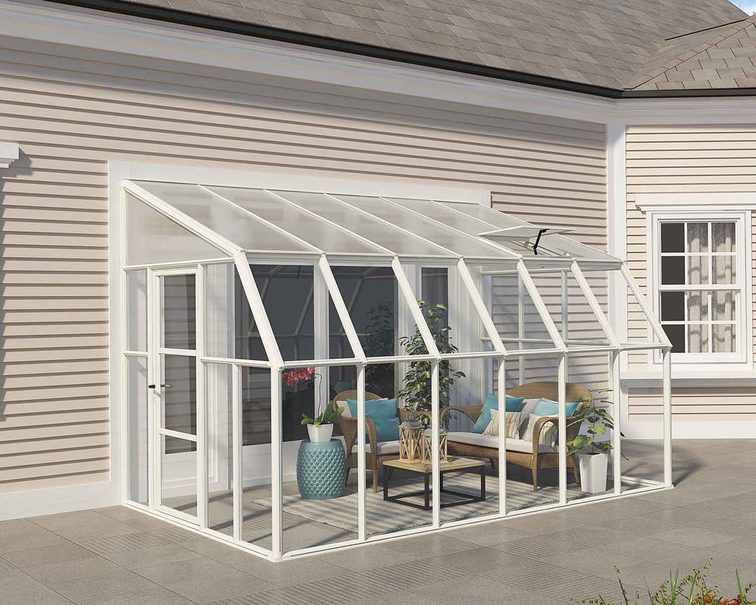8ft x 12ft white SunRoom with polycarbonate panels and an aluminum frame, attached to a house with plants and a seating area inside