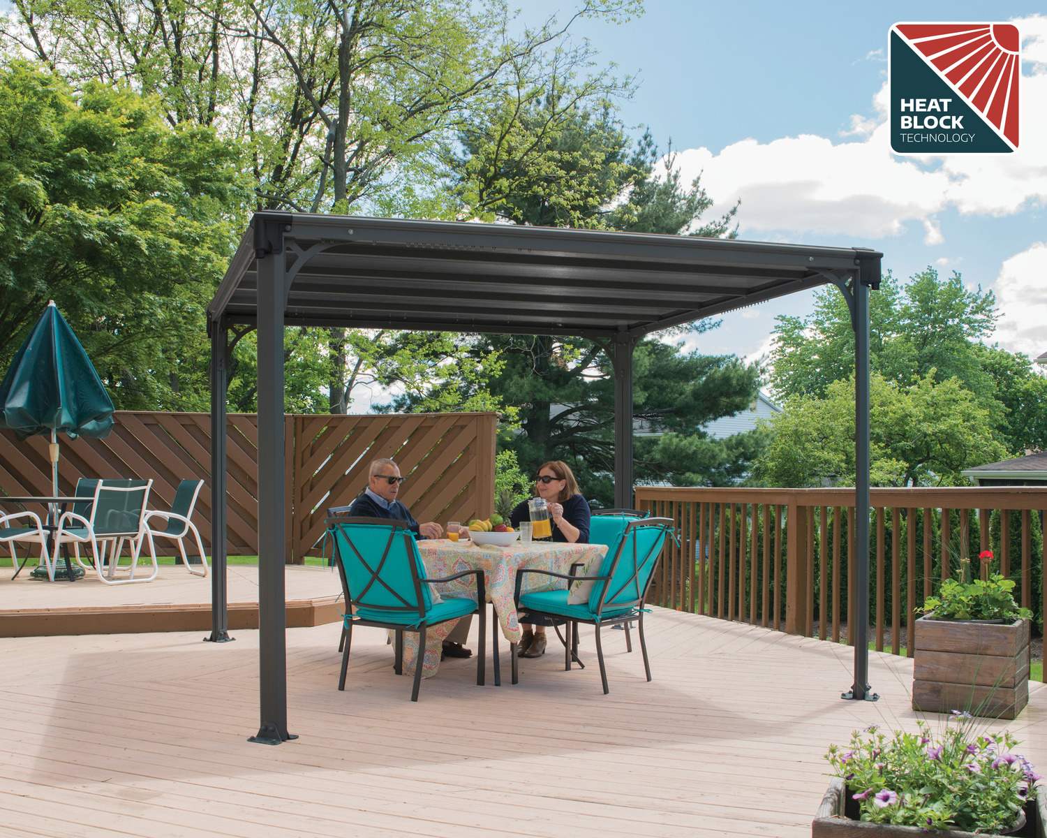 Milano 10ft x 10ft grey aluminum gazebo with a modern design, featuring a wicker sofa set surrounded by greenery
