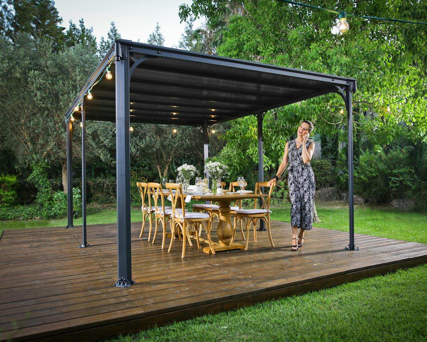 Milano 10ft x 14ft grey aluminum gazebo with a modern design, ideal for an outdoor dining area with string lights on a wooden deck