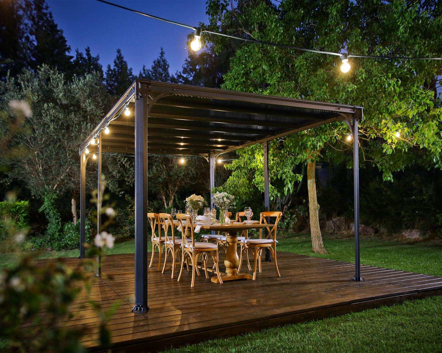 Milano 10ft x 14ft grey aluminum gazebo with a modern design, ideal for an outdoor dining area with string lights on a wooden deck