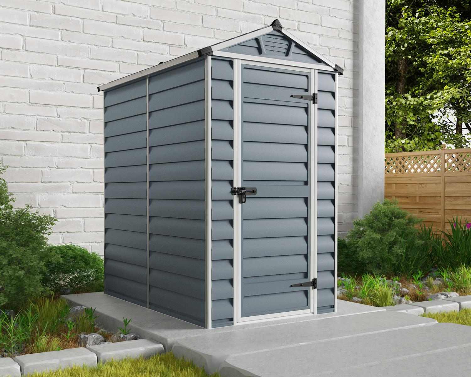 Grey Skylight plastic storage shed, 4 ft x 6 ft, with modern design and white trim, on a concrete base in a backyard