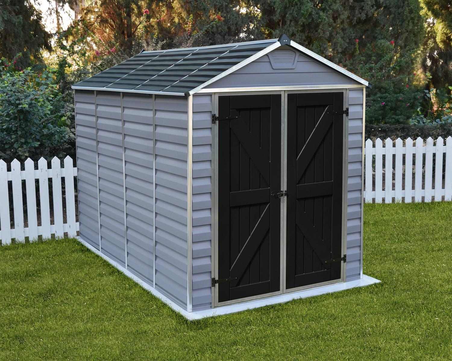 Skylight Plastic Storage Shed 6ft x 10ft in Grey Deco, featuring a stylish design, placed in a green yard next to a white picket fence