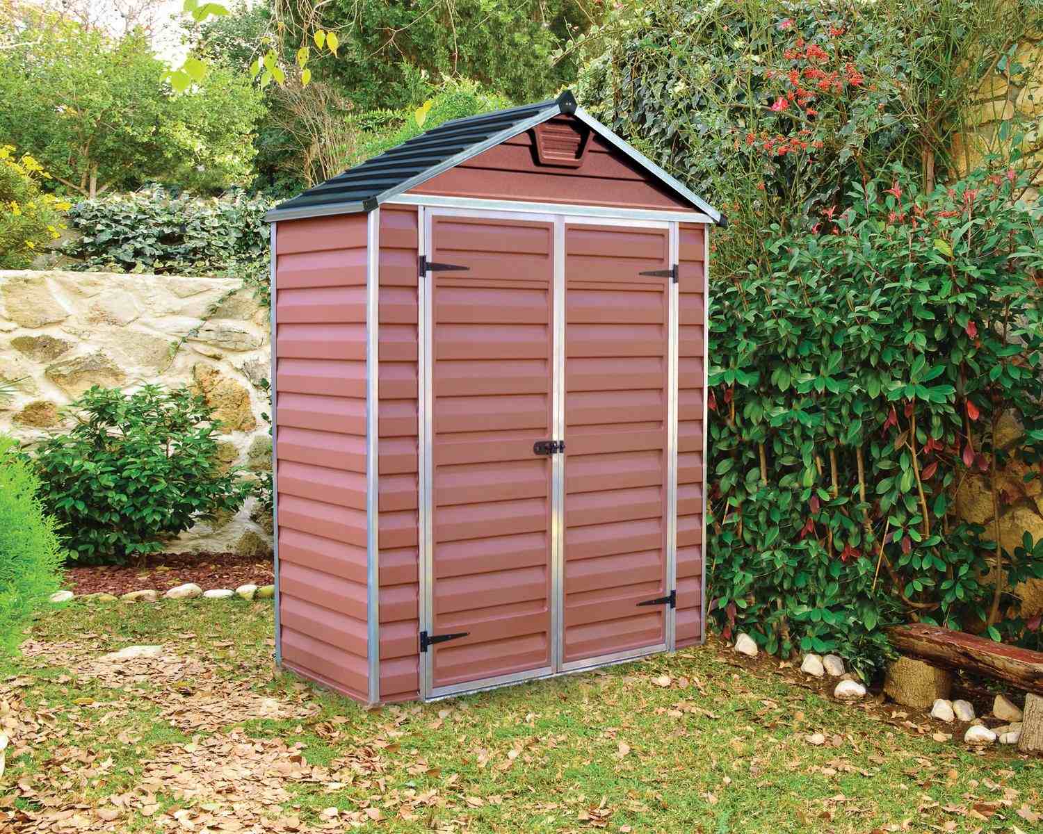 Amber Skylight plastic storage shed, 6 ft x 3 ft, featuring a stylish design with a slanted roof in a lush backyard
