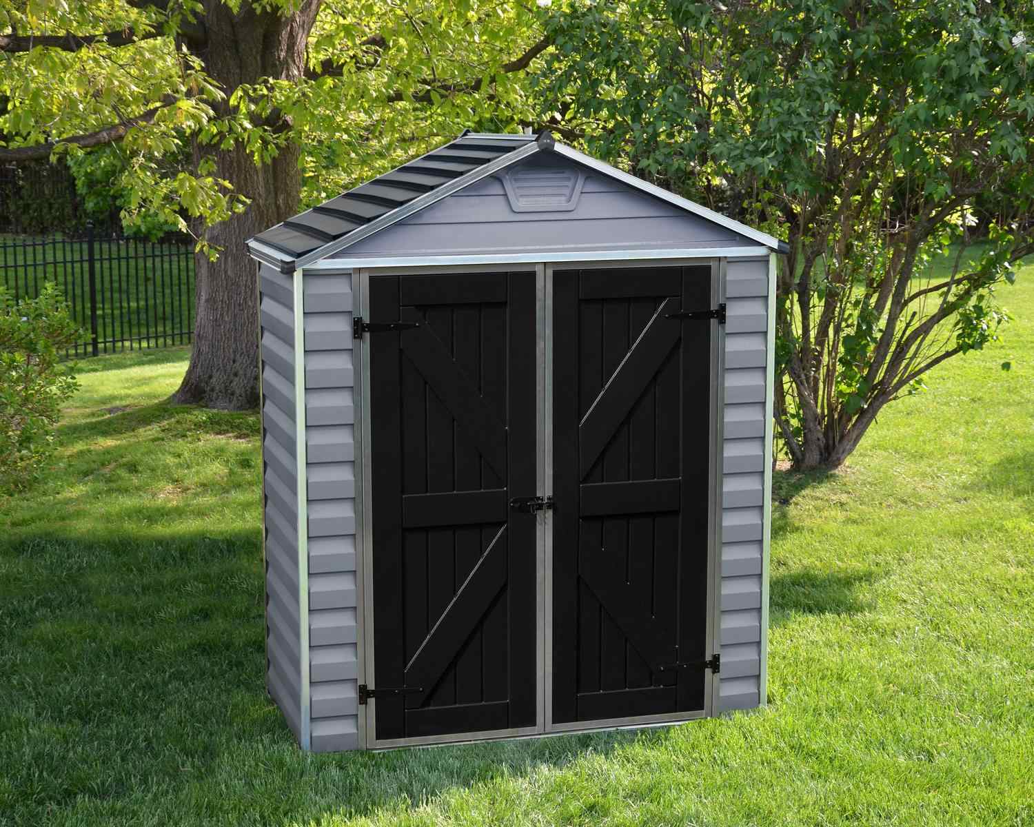 Grey Skylight plastic storage shed, 6 ft x 3 ft, with a sleek design, set in a garden with greenery