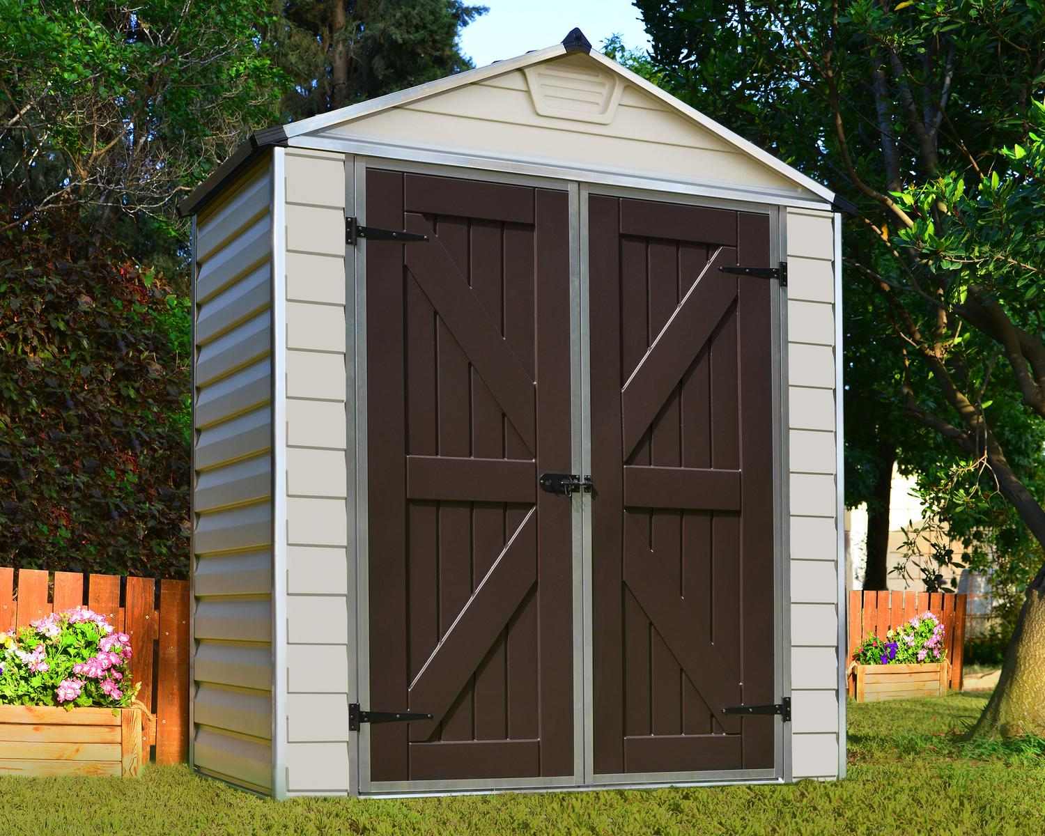 Tan SkyLight plastic storage shed, 6 ft x 3 ft, with sleek design and brown doors, in a sunny backyard with trees and flowers
