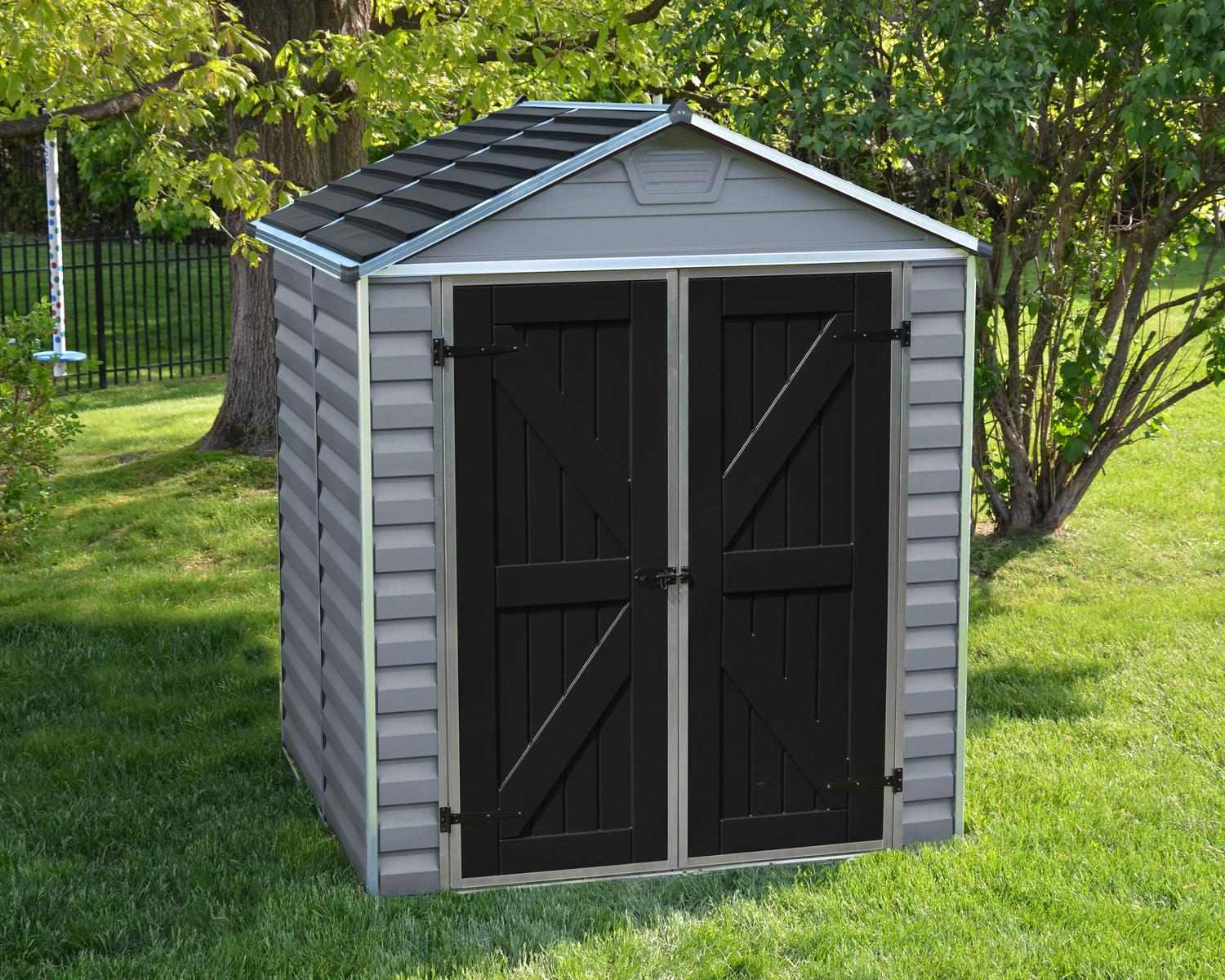 Grey skylight plastic storage shed, 6 ft x 5 ft, featuring a modern design with black doors, set on a green lawn with trees