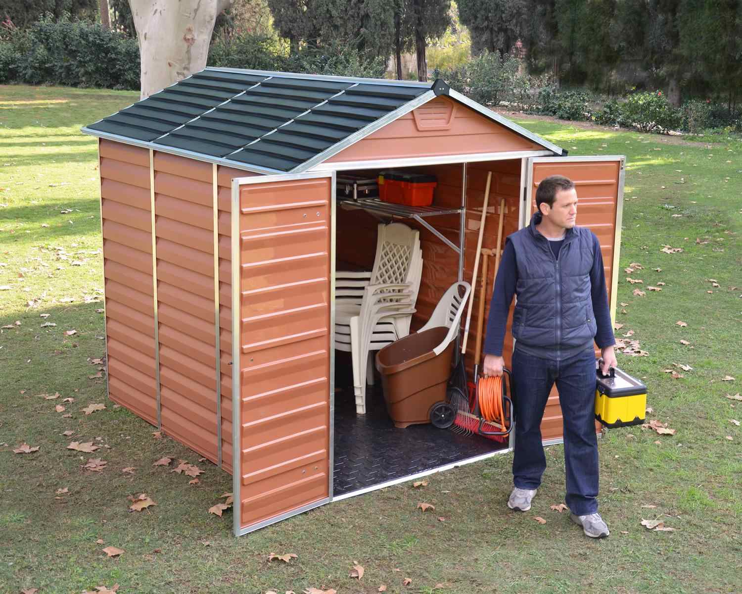 Amber skylight plastic storage shed, measuring 6 ft x 8 ft, featuring a modern design in an outdoor setting with greenery