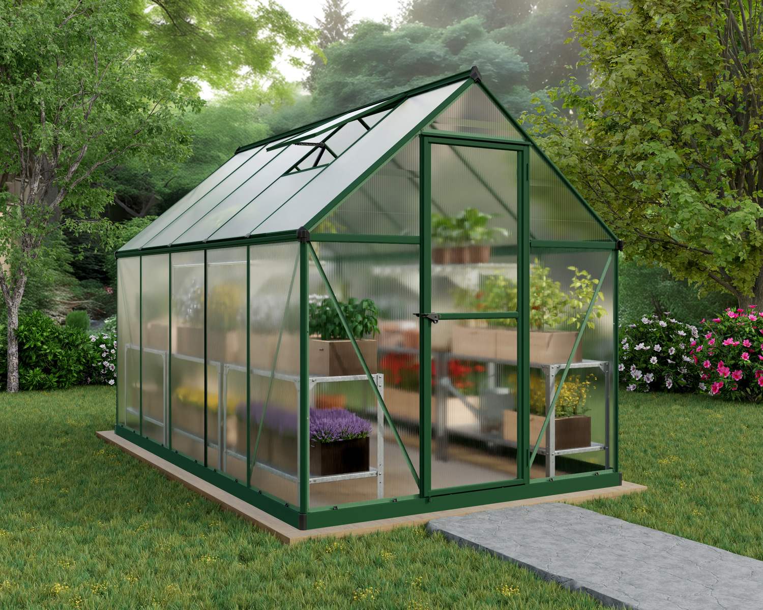 6ft x 10ft green Mythos greenhouse with a sturdy aluminum frame and clear polycarbonate panels, with plants in a lush garden setting