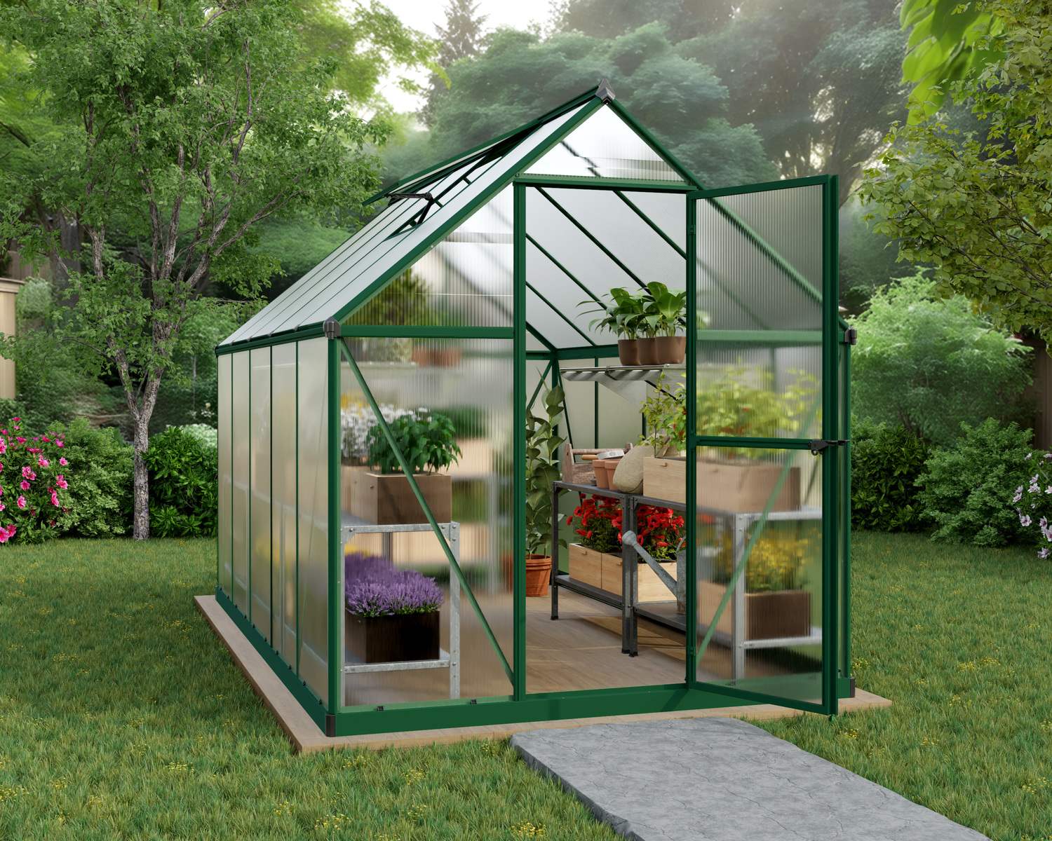 6ft x 10ft green Mythos greenhouse with a sturdy aluminum frame and clear polycarbonate panels, with plants in a lush garden setting