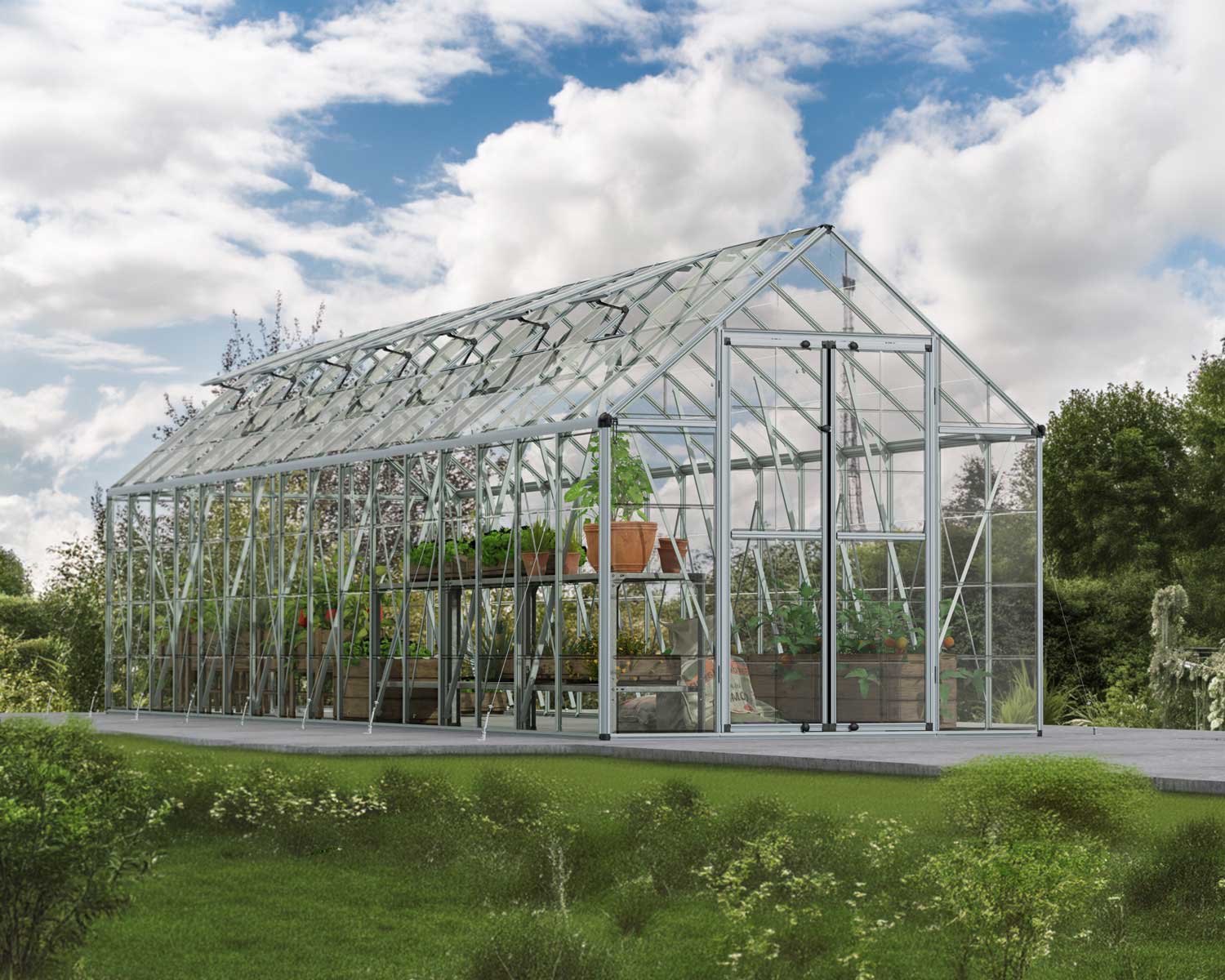 Spacious Silver SnapGrow 8ft x 32ft greenhouse with a sturdy aluminum frame and clear polycarbonate panels, filled with plants in a garden