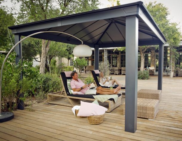 outdoor gazebo on a deck patio is used by a couple for relaxation