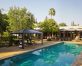 Poolside aluminium gazebo with garden furniture