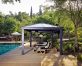Poolside aluminium gazebo with garden furniture