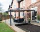 Outdoor Aluminium gazebo with polycarbonate roof panels on a garden patio