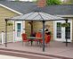 Palermo 12&#039;x12&#039; grey aluminum gazebo with polycarbonate roof panels on a deck patio with garden dining furniture