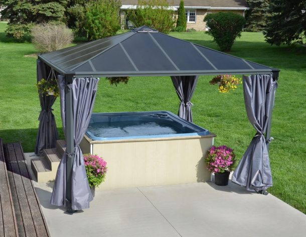 12&#039;x12&#039; hot tub aluminum gazebo with polycarbonate roof panels and privacy curtains to cover a hot tub on a concrete patio