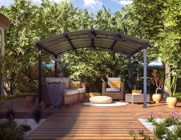 Arched aluminium pergola 11' x 14' on a patio deck with garden furniture