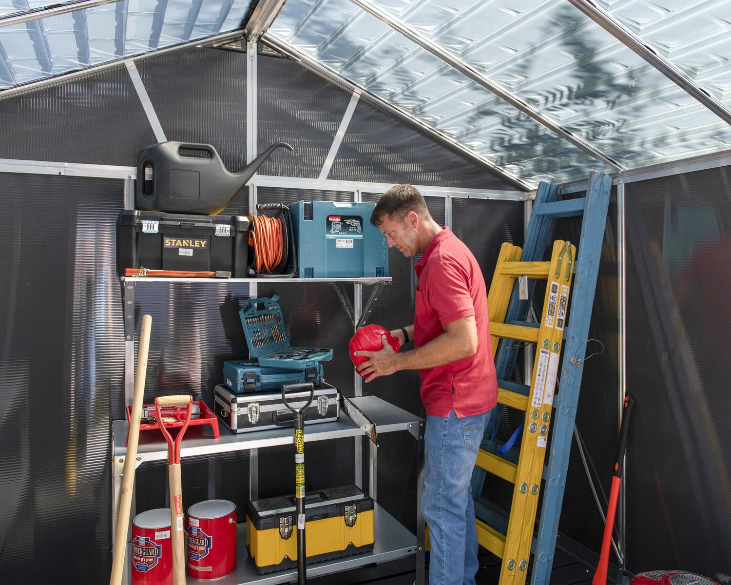 Organizing of tools in large Plastic storage shed with a skylight roof