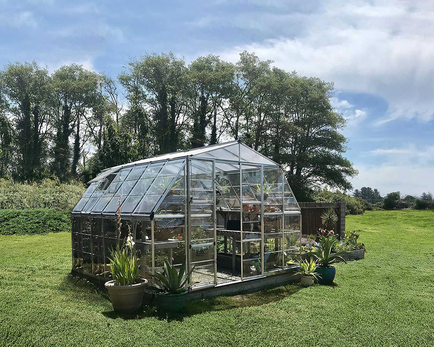 American Greenhouse on open field with clear panels