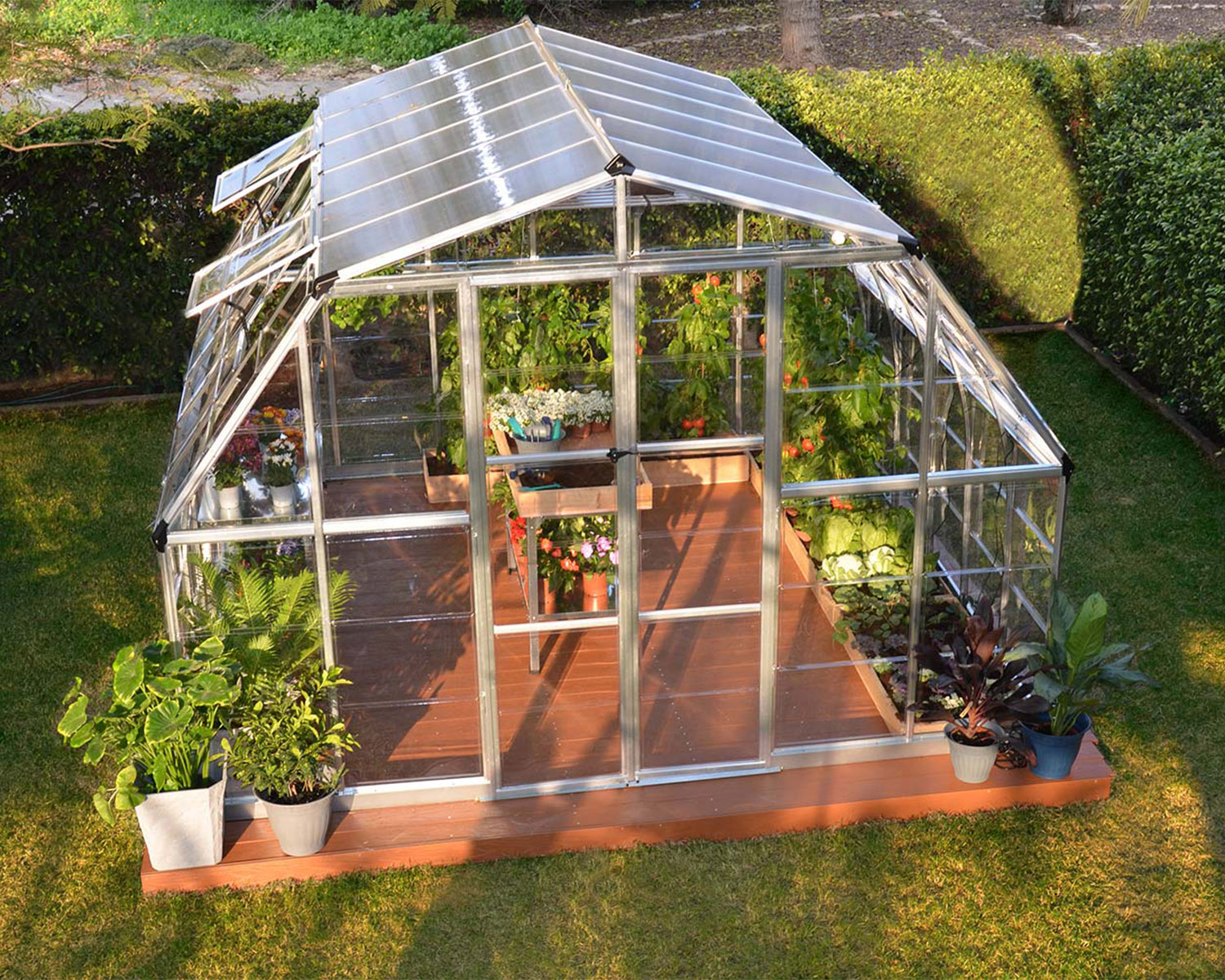 above view of Greenhouse Kit Americana 12 ft. x 12 ft. with clear polycarbonate panels in a garden