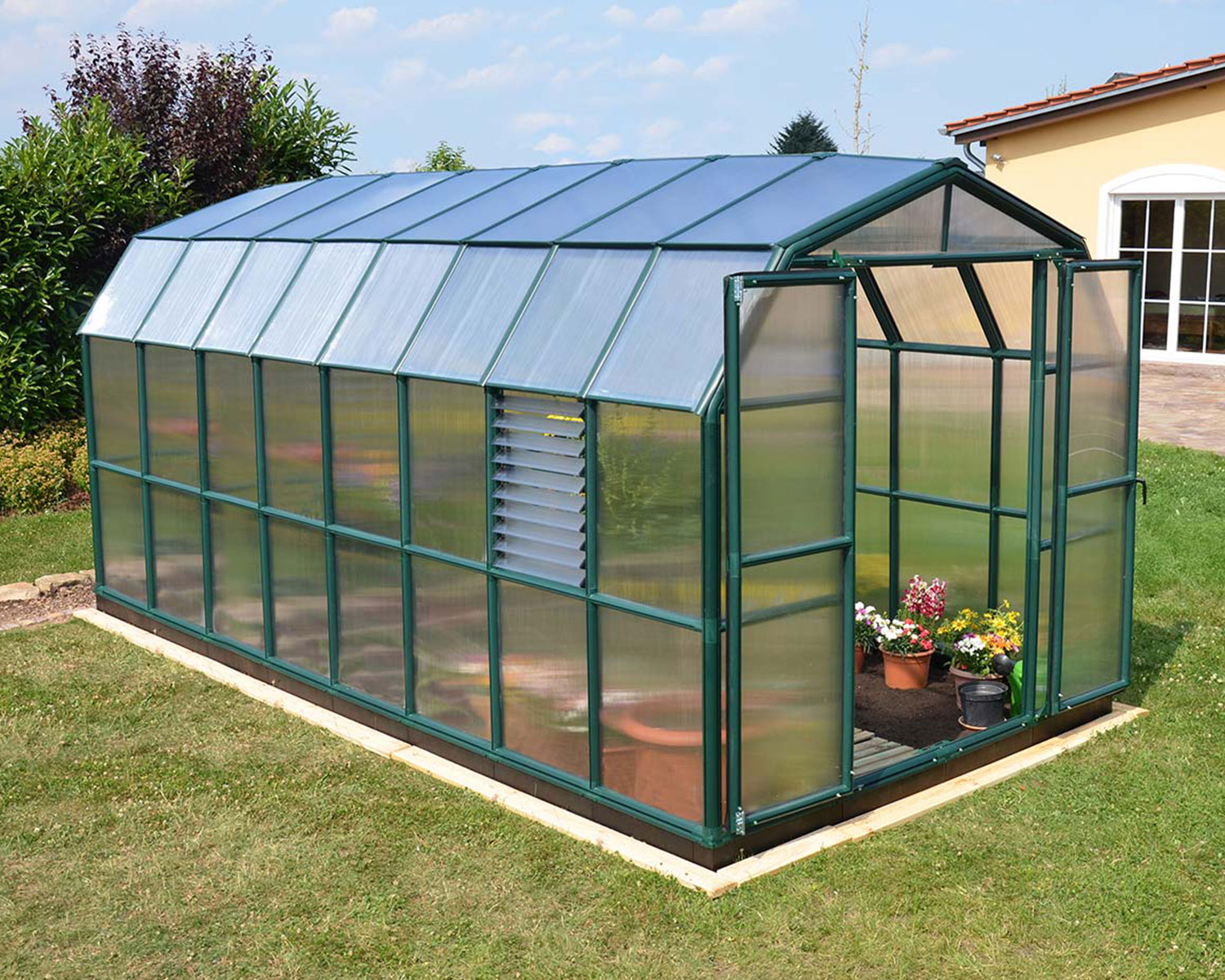 Greenhouse Prestige 8 ft. x 16 ft. Green Structure & Twin Wall Panels on a lawn