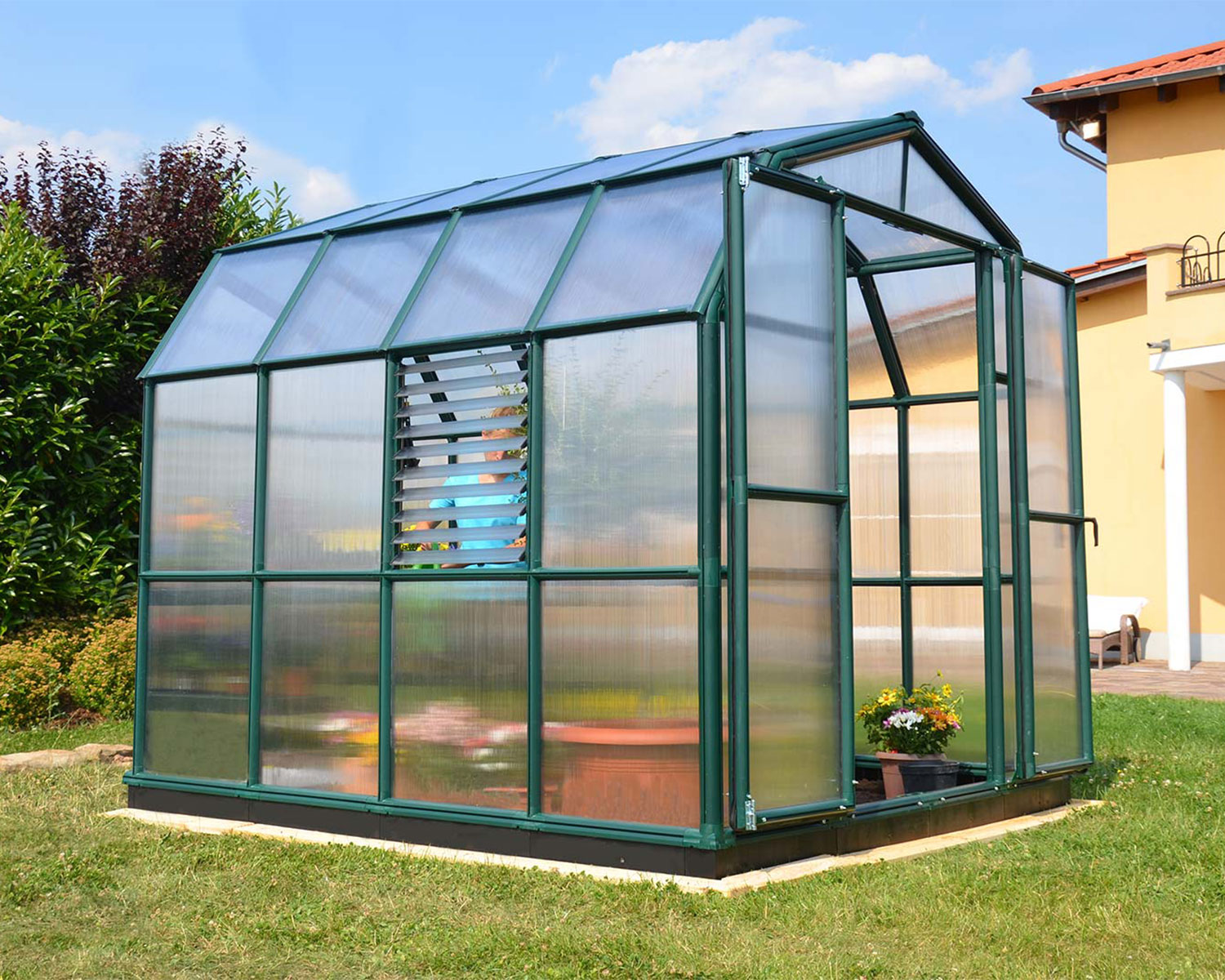 Greenhouse Prestige 8 ft. x 8 ft. Green Structure &amp; Twin Wall Panels on a lawn