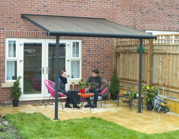 Grey Aluminium Patio Cover with Bronze-tinted twin-wall polycarbonate roof panels protect garden furniture