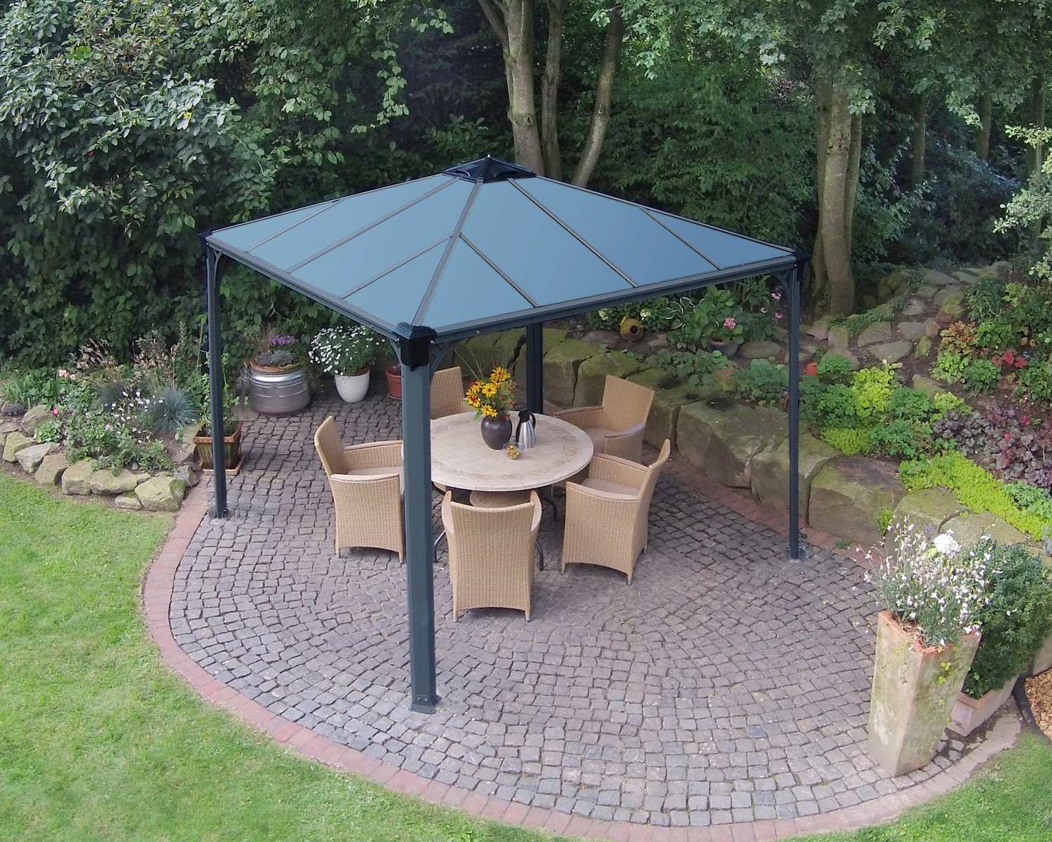 Palermo 10ft x 10ft grey aluminum gazebo with a sleek design and sturdy frame, featuring a dining set on a deck in a garden