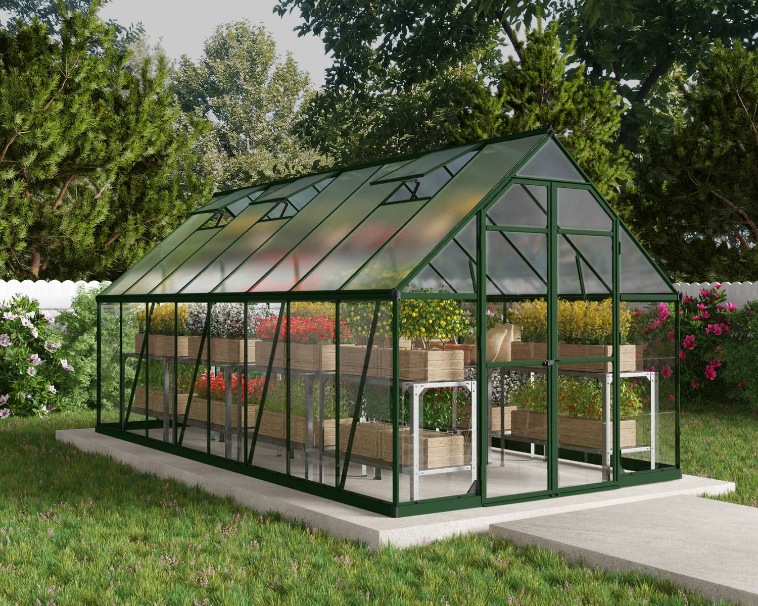 8ft x 16ft green Balance greenhouse with polycarbonate panels and aluminium frame, filled with plants in a lush garden