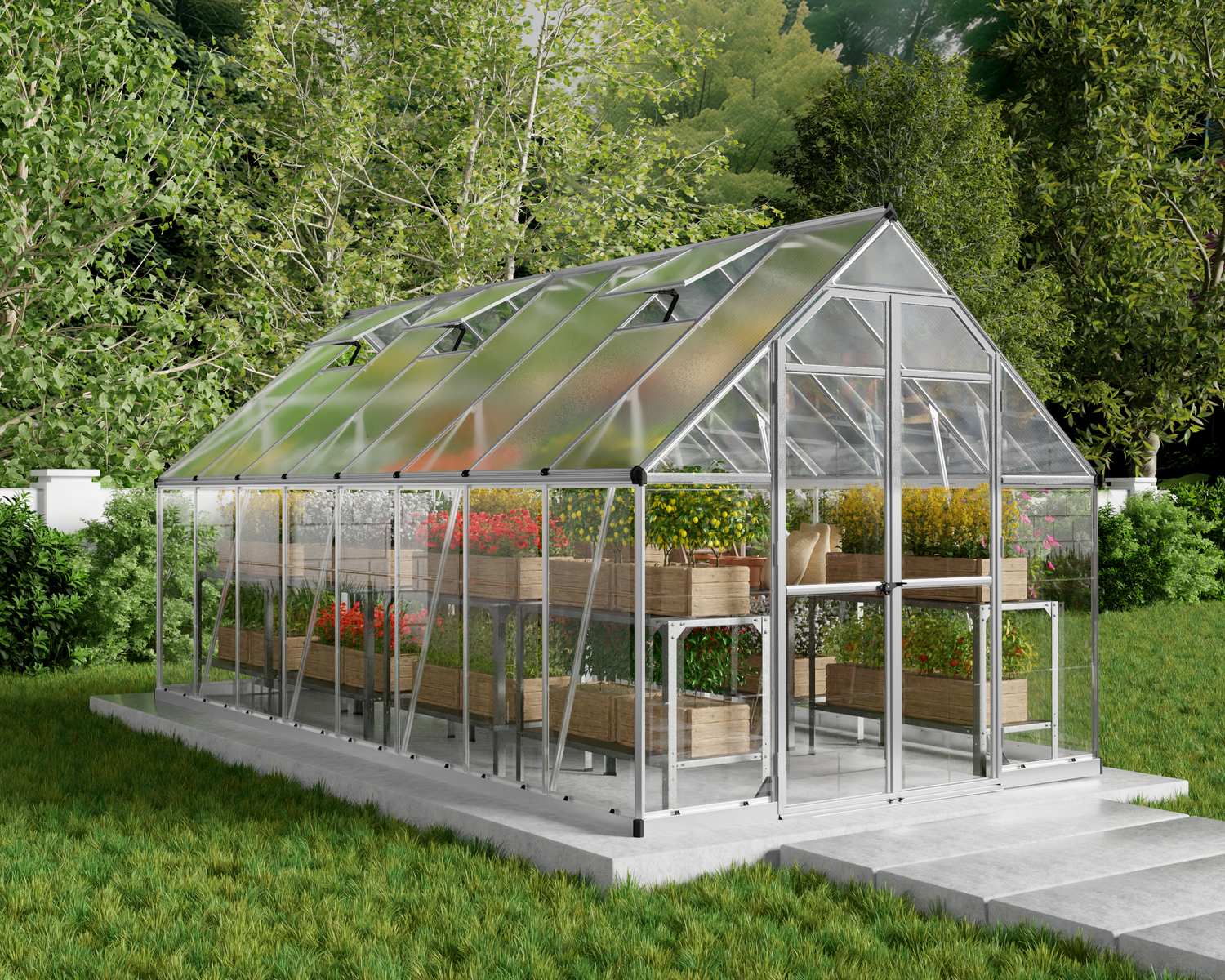 8ft x 16ft silver Balance greenhouse with polycarbonate panels and a sturdy aluminium frame, filled with plants, set in a lush garden with a green lawn