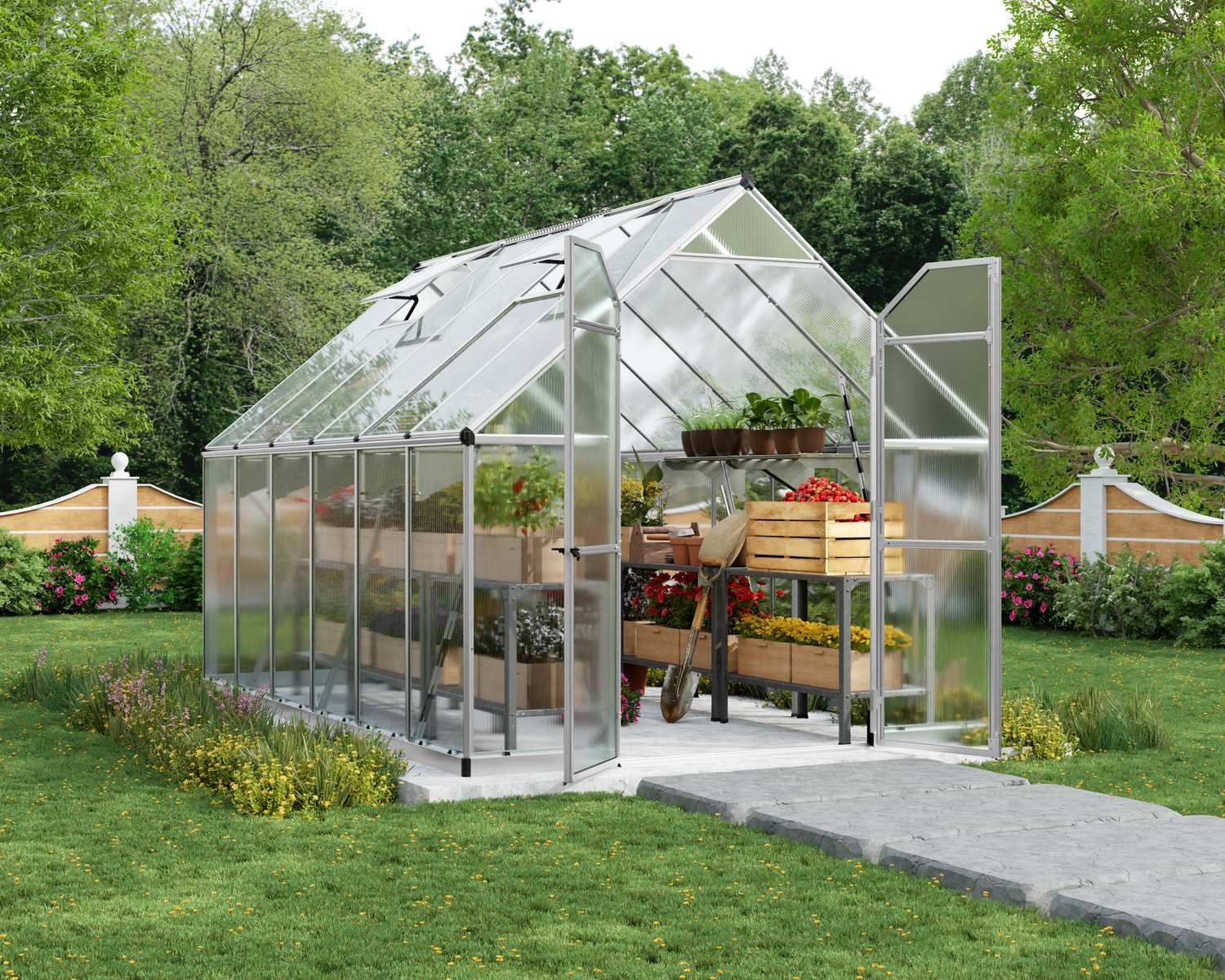 Essence 8x12 Silver greenhouse with polycarbonate panels, double doors, and a sloped roof, set in a vibrant garden