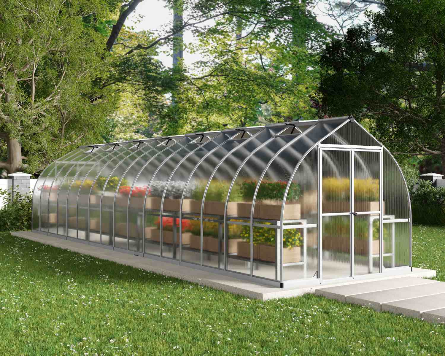 Bella 8x32 Silver greenhouse with polycarbonate multiwall panels, double doors, and a gable roof, set in a lush garden