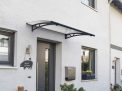 Grey Altair 1.5m x 0.9m door canopy with clear polycarbonate panels, mounted above a door, providing protection from the elements