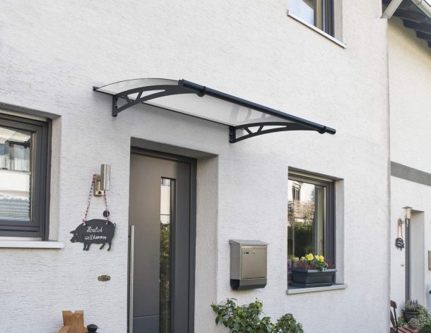 Grey Altair 1.5m x 0.9m door canopy with clear polycarbonate panels, mounted above a door, providing protection from the elements