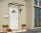 Venus 1.5m x 0.9m door canopy in grey with clear polycarbonate panels, offering sleek and durable protection for entryways