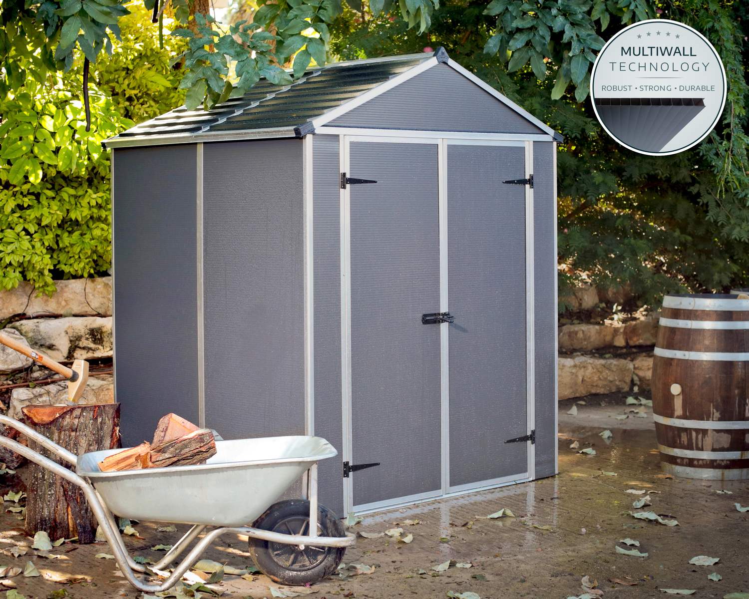 6ft x 5ft grey Rubicon garden shed with a sturdy aluminum frame and multiwall polycarbonate panels, set in a neat backyard surrounded by greenery