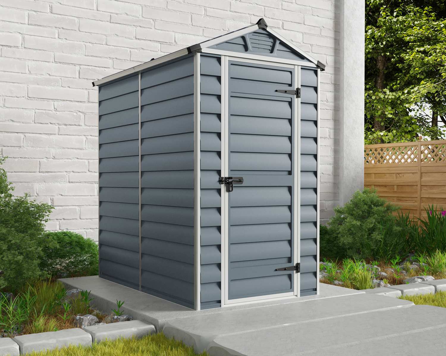 Grey 4ft x 6ft Skylight garden shed with a durable aluminum frame and polycarbonate panels, placed on a concrete base amidst greenery