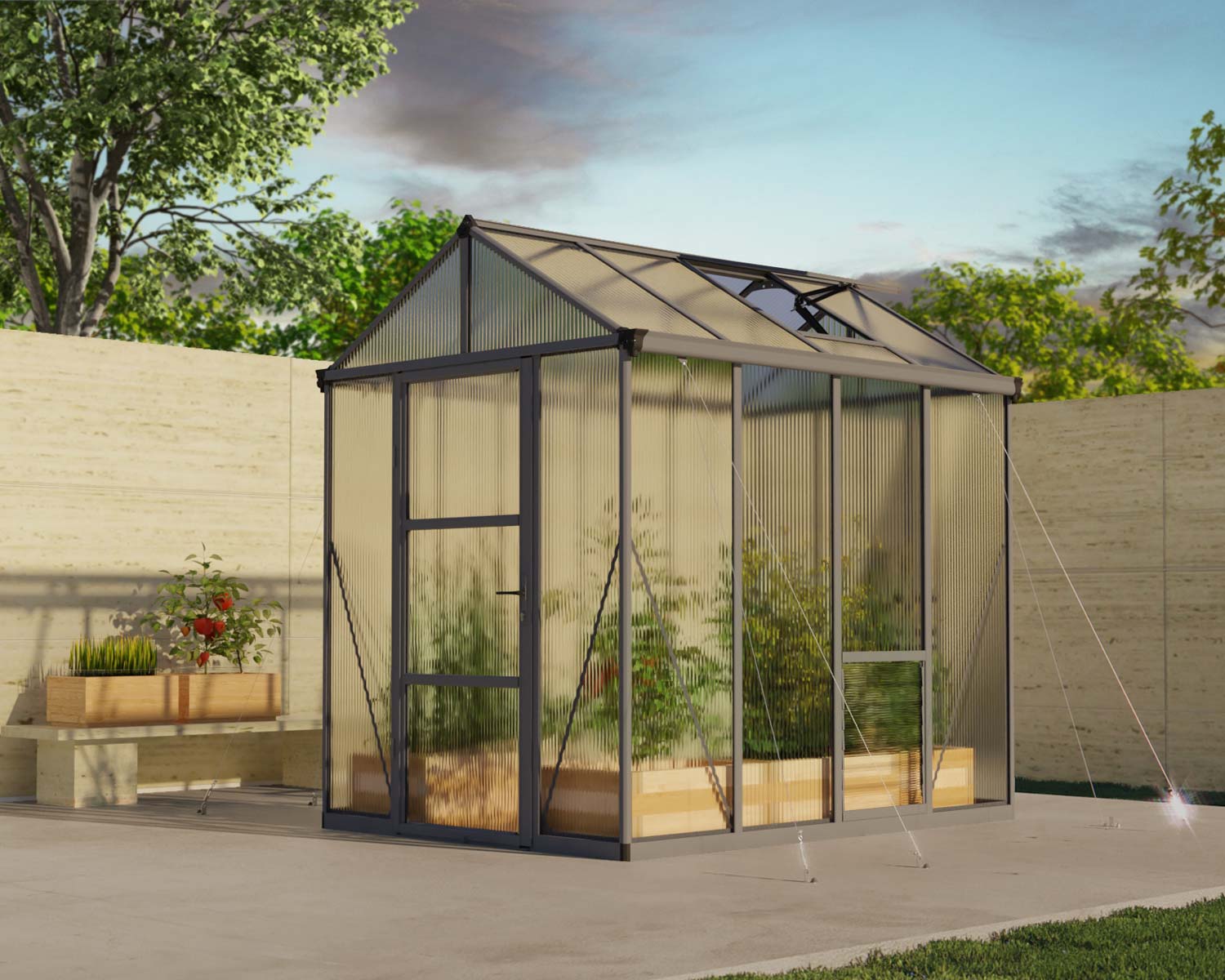 6ft x 8ft grey Glory greenhouse with an aluminum frame and multi-wall polycarbonate panels, set on a patio beside a raised garden bed