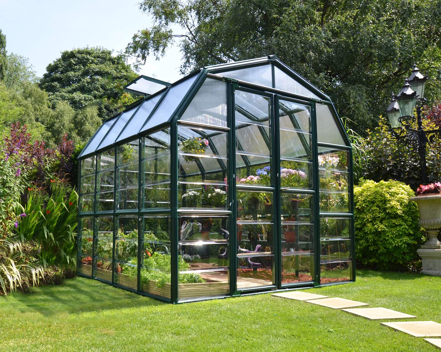 8ft x 8ft green Grand Gardener greenhouse with clear polycarbonate panels and a sturdy aluminum frame, ideal for gardening and plant care