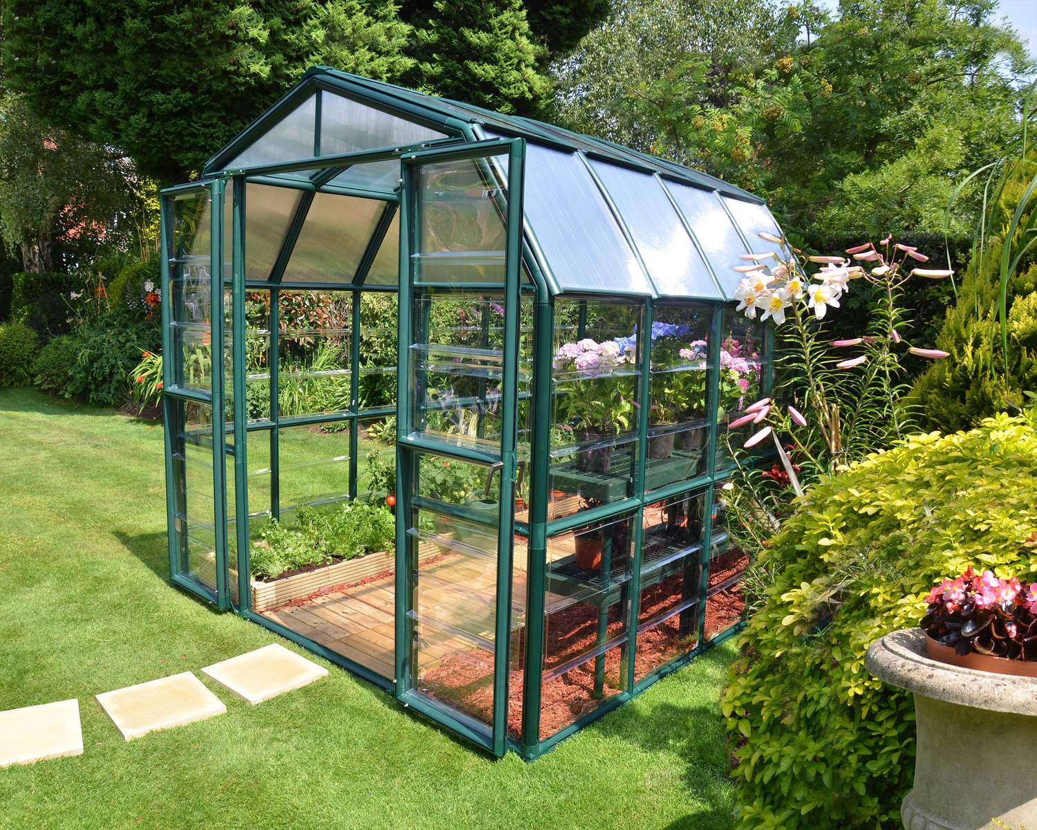 8ft x 8ft green Grand Gardener greenhouse with clear polycarbonate panels and a sturdy aluminum frame, ideal for gardening and plant care