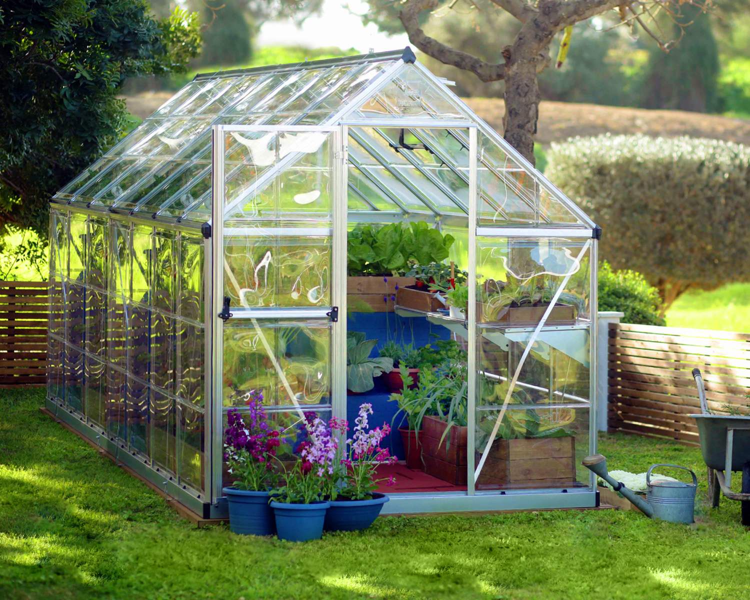 6ft x 14ft silver Harmony greenhouse with clear polycarbonate panels and an aluminum frame, placed in a garden setting