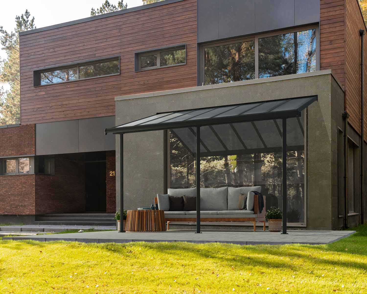 Grey Sierra patio cover, 3m x 4.3m, with an aluminum frame and clear polycarbonate panels for durable shade and weather protection