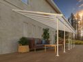 White Feria patio cover, 4m x 8.5m, with an aluminum frame and clear polycarbonate panels, providing shade and protection for large outdoor areas