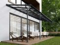 Grey Sierra patio cover, 2.2m x 6.7m, with an aluminum frame and clear polycarbonate panels, offering outdoor shade and weather protection