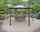 Sleek Monaco 3.9m x 4.5m grey garden gazebo with contemporary design and durable polycarbonate panels in an outdoor setting