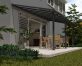 Grey Olympia patio cover, 3m x 6.2m, with an aluminum frame and clear polycarbonate panels, offering outdoor shade and protection